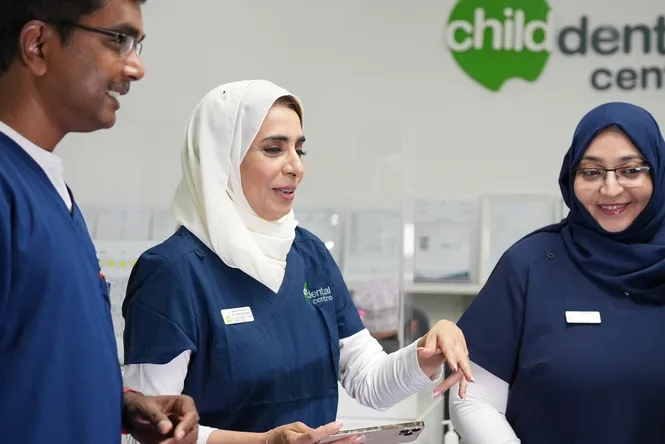 Dentist explaining a dental care plan to parent and child